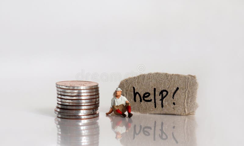The `help! ‘ word written on a torn cardboard. A stack of coins and a miniature man sitting. royalty free stock image