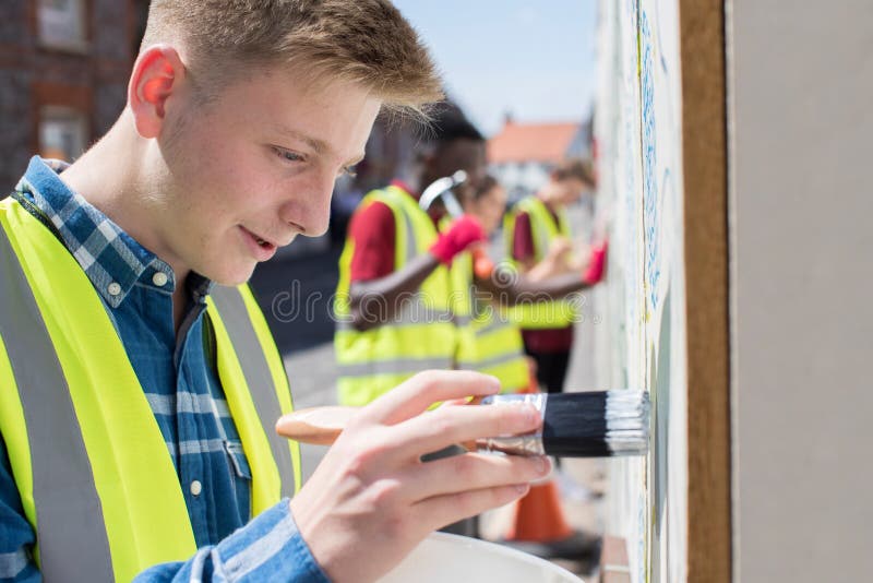 Group Of Helpful Teenagers Creating And Maintaining Community Ar stock image