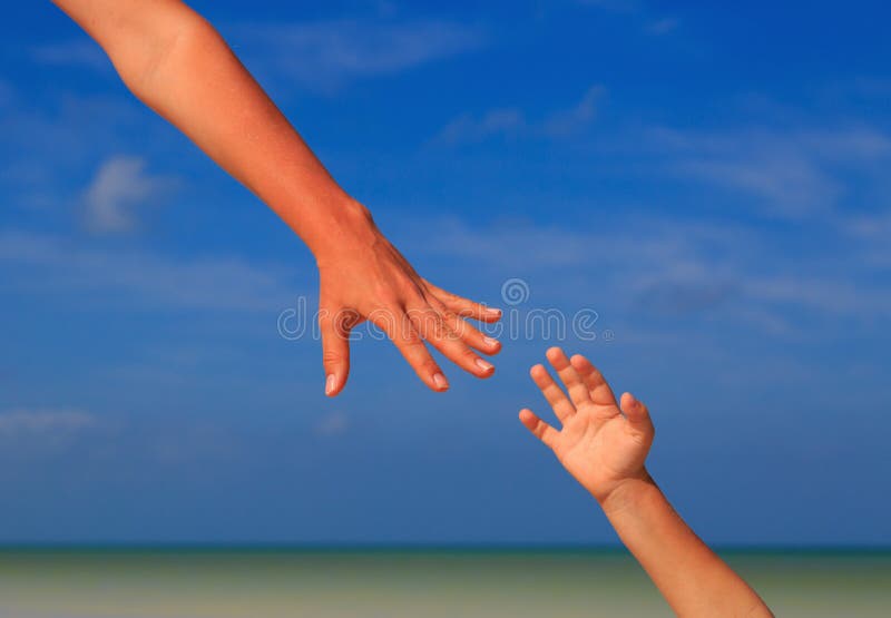 Helping hand of mother and child on sky at the sea royalty free stock photo Helping hand of mother and child on sky at the sea royalty free stock photo
