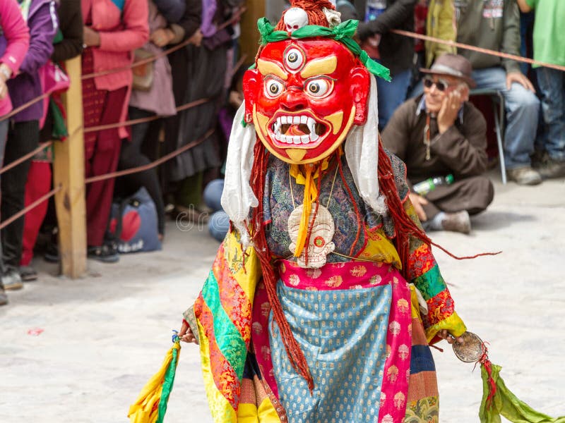 Monk in dharmapala mask performs a religious masked and costumed mystery dance of Tantric Tibetan Buddhism on Cham Dance Festival