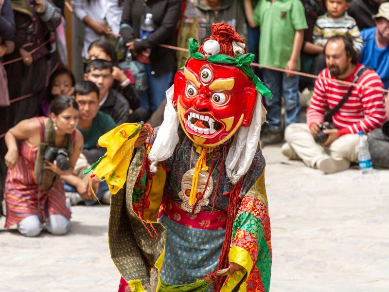Monk in dharmapala mask performs a religious masked and costumed mystery dance of Tantric Tibetan Buddhism on Cham Dance Festival