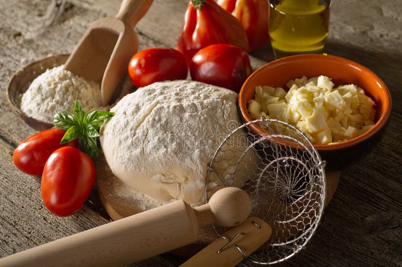 Ingredients for homemade pizza on wood background. Ingredients for homemade pizza on wood background