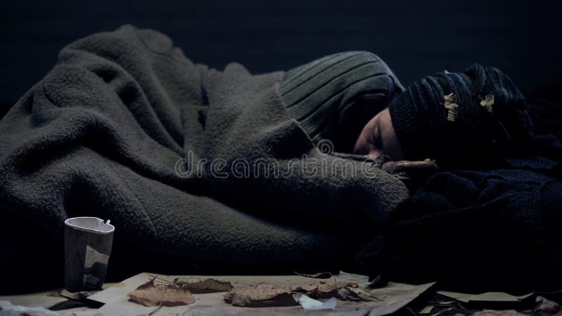 Homeless person covered by blanket sleeping on city street, poverty concept, stock photo. Homeless person covered by blanket sleeping on city street, poverty concept, stock photo