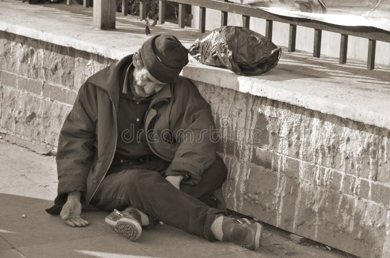 ISTANBUL TURKEY OCTOBER 08: Homelessness Muslim man sleep on the side walk in the heart of downtown Istanbul on october 08 2013. The absolute poverty line for Turkey was US $4 per capita per day. ISTANBUL TURKEY OCTOBER 08: Homelessness Muslim man sleep on the side walk in the heart of downtown Istanbul on october 08 2013. The absolute poverty line for Turkey was US $4 per capita per day.