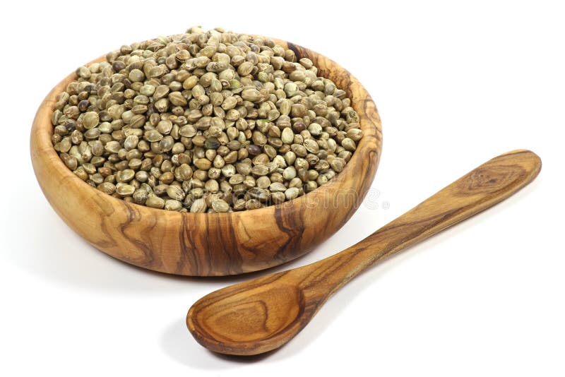 Hemp seeds. Wooden bowl with hemp seeds isolated on white background royalty free stock photo