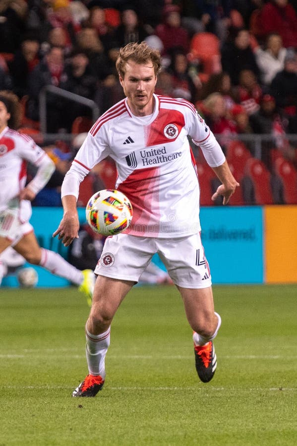 Toronto, ON, Canada - April 20, 2024: Henry Kessler #4 defender of the New England Revolution runs with the ball during the MLS Regular Season match between Toronto FC (Canada) and New England Revolution (USA) at BMO Field. Toronto, ON, Canada - April 20, 2024: Henry Kessler #4 defender of the New England Revolution runs with the ball during the MLS Regular Season match between Toronto FC (Canada) and New England Revolution (USA) at BMO Field