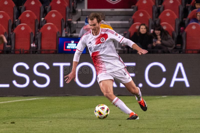 Toronto, ON, Canada - April 20, 2024: Henry Kessler #4 defender of the New England Revolution moves with the ball during the MLS Regular Season match between Toronto FC (Canada) and New England Revolution (USA) at BMO Field. Toronto, ON, Canada - April 20, 2024: Henry Kessler #4 defender of the New England Revolution moves with the ball during the MLS Regular Season match between Toronto FC (Canada) and New England Revolution (USA) at BMO Field