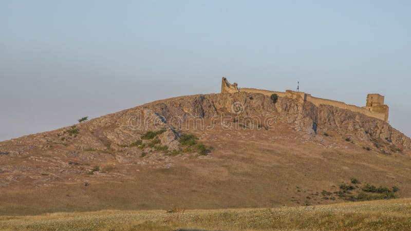 View of byzantine fortress of Heracleia at the village Enisala at sunset. View of byzantine fortress of Heracleia at the village Enisala at sunset