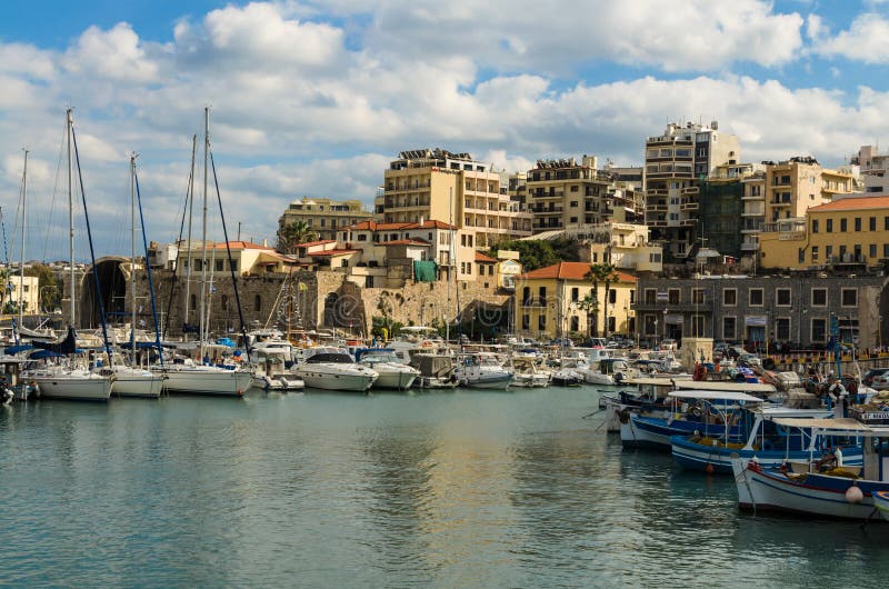 HERAKLION, GREECE - November, 2017: colorful fishing boats and yachts in old Venetian fortress, Heraklion port, Crete