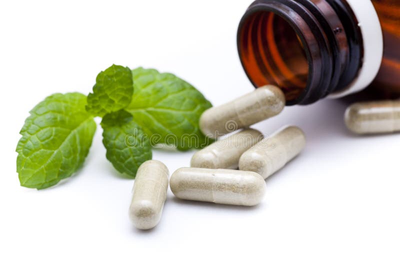 Organic capsule with mint leaves. Green herbal drug medicine stock images, royalty-free photos and pictures