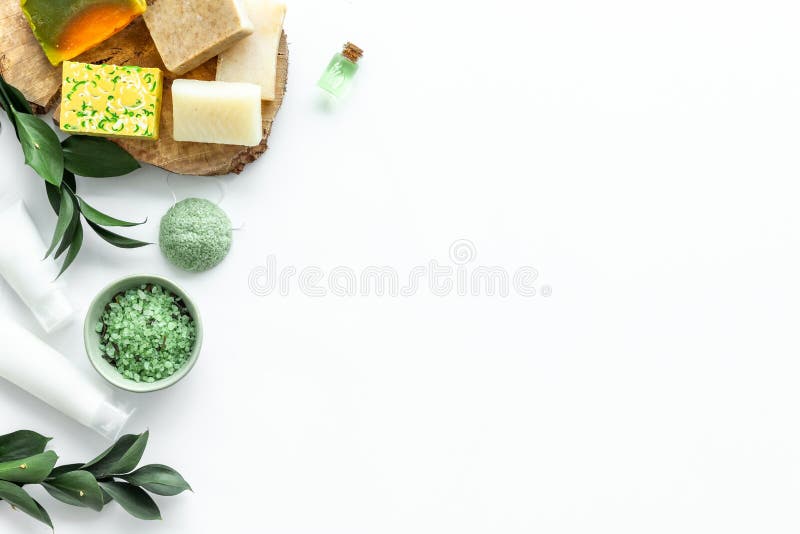 Herbal cosmetic set for spa with soap and bath salt on white background flatlay mock-up. Herbal cosmetic set for spa with soap and bath salt on white desk stock photo Herbal cosmetic set for spa with soap and bath salt on white background flatlay mock-up. Herbal cosmetic set for spa with soap and bath salt on white desk stock photo