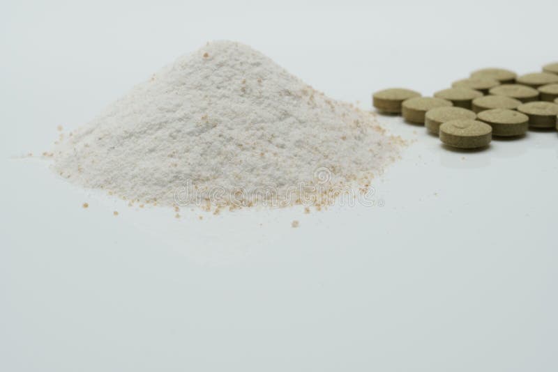 Herbal tablets and dry powder stock photo
