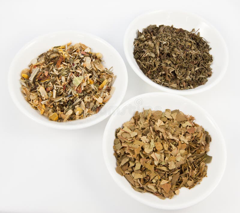 Herbal teas in small white bowls