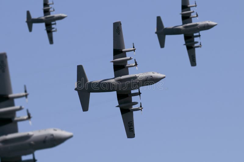 A fleet of USAF transport planes flying overhead. (Shot with minimum depth of field. Focus is on the centre aircraft. ). A fleet of USAF transport planes flying overhead. (Shot with minimum depth of field. Focus is on the centre aircraft. )