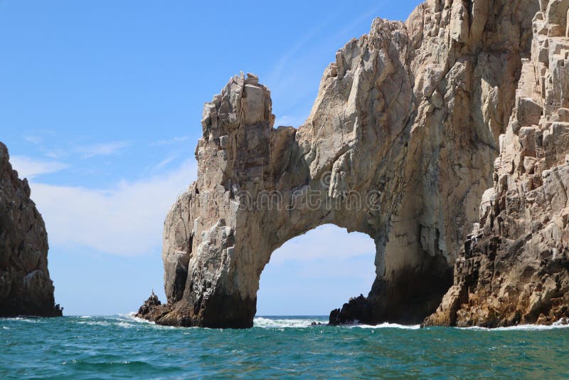 A beautiful view of The Arch, the iconic landmark along the rocky shoreline of the cape in Los Cabos. A beautiful view of The Arch, the iconic landmark along the rocky shoreline of the cape in Los Cabos