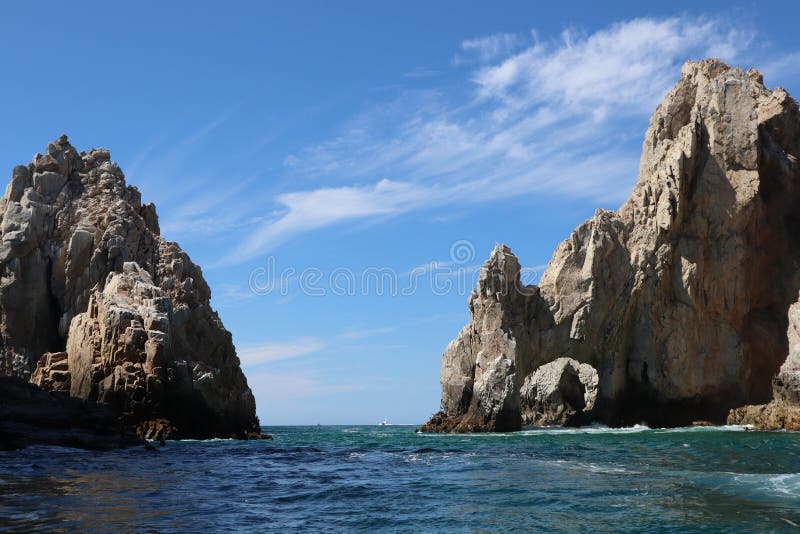 A beautiful view of The Arch, the iconic landmark along the rocky shoreline of the cape in Los Cabos,. A beautiful view of The Arch, the iconic landmark along the rocky shoreline of the cape in Los Cabos,