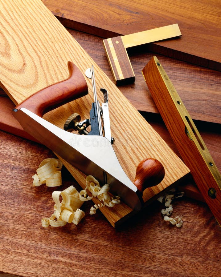 A plane, square and level on a wood background. A plane, square and level on a wood background