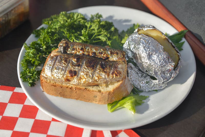 Baked Herring With Lemon And Spices On A White Wooden Background. Tasty
