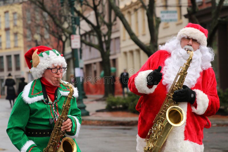 Santa and his elf playing tenor saxophone at the Victorian Stroll in Troy, New York