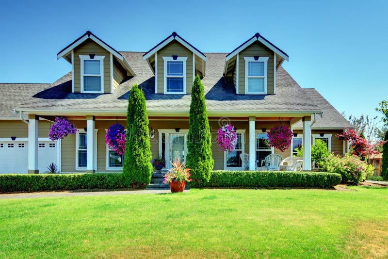 American Country farm luxury house with porch and beautiful flowers. American Country farm luxury house with porch and beautiful flowers.