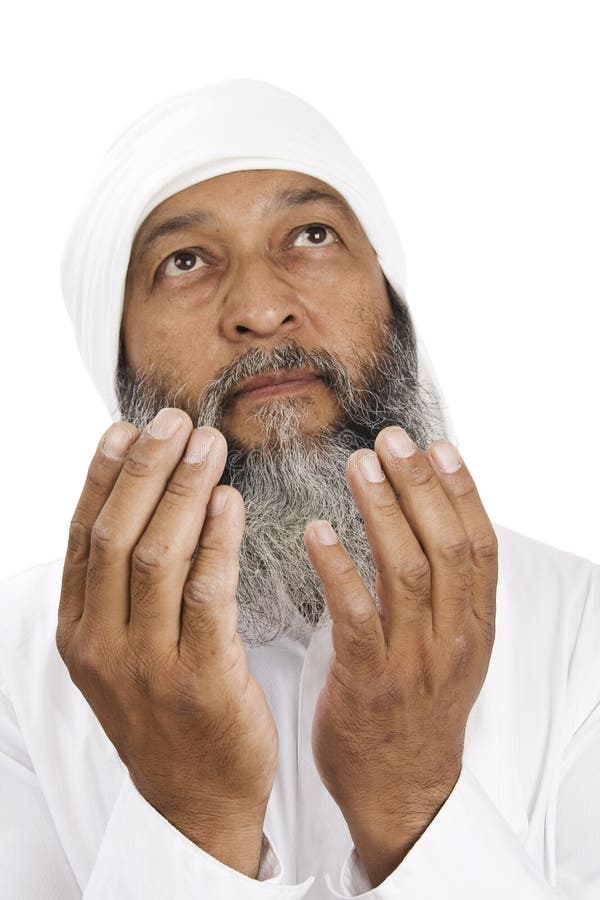 Stock image of Arab man praying over white background, selective focus on hands. Stock image of Arab man praying over white background, selective focus on hands