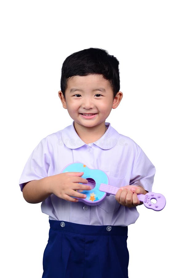 Het Aziatische Thaise jonge geitje van de kleuterschoolstudent in school het eenvormige spelen aan stock foto Het Aziatische Thaise jonge geitje van de kleuterschoolstudent in school het eenvormige spelen aan stock foto