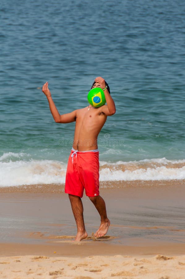 Het Braziliaanse jong geitje jongleren met met voetbal, Copacabana, Rio de Janeiro royalty-vrije stock afbeeldingen Het Braziliaanse jong geitje jongleren met met voetbal, Copacabana, Rio de Janeiro royalty-vrije stock afbeeldingen