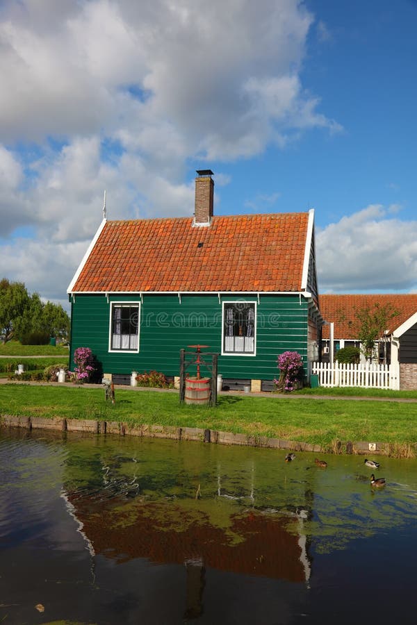 The charming rural house with a red roof in the Dutch village. The charming rural house with a red roof in the Dutch village