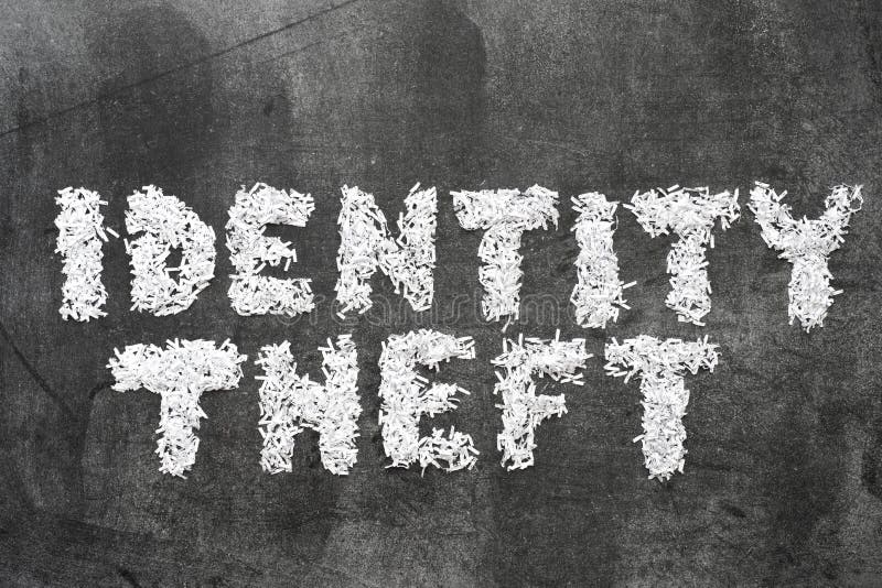 Identity theft phrase made from shredded paper on blackboard surface. Identity theft phrase made from shredded paper on blackboard surface