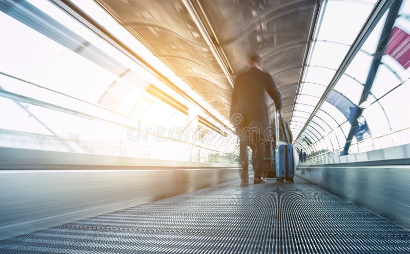 A Blurred passanger on a skywalk in a modern airport. ideal for websites and magazines layouts. A Blurred passanger on a skywalk in a modern airport. ideal for websites and magazines layouts.