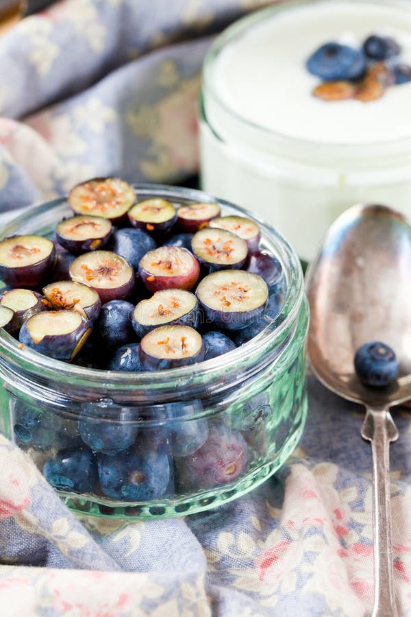Het dienen van Yoghurt met Gehele Verse Bosbessen en Havermeel op Oude Rustieke Lijst stock afbeelding Het dienen van Yoghurt met Gehele Verse Bosbessen en Havermeel op Oude Rustieke Lijst stock afbeelding