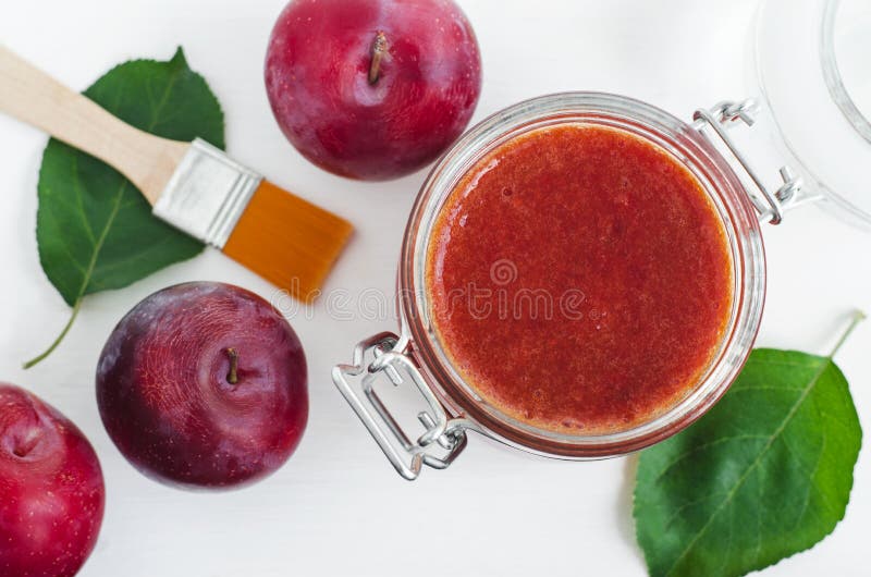 Homemade plum face mask in a glass jar. DIY cosmetics and spa. Top view, copy space. Homemade plum face mask in a glass jar. DIY cosmetics and spa. Top view, copy space.