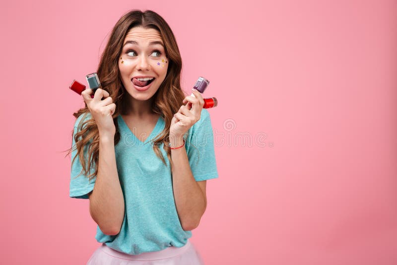 Het emotionele jonge nagellak van de vrouwenholding en opzij het kijken stock foto's Het emotionele jonge nagellak van de vrouwenholding en opzij het kijken stock foto's