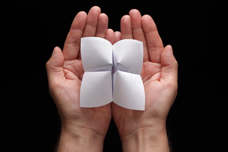 Origami fortune teller with blank choices in cupped hands. Origami fortune teller with blank choices in cupped hands