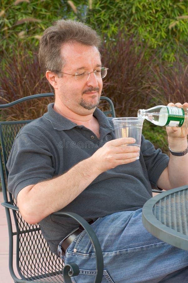 Man poring water into glass. Man poring water into glass