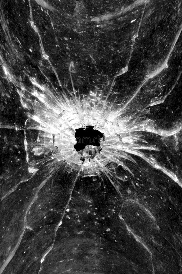 Het gat van de kogel in glas stock afbeelding Het gat van de kogel in glas stock afbeelding