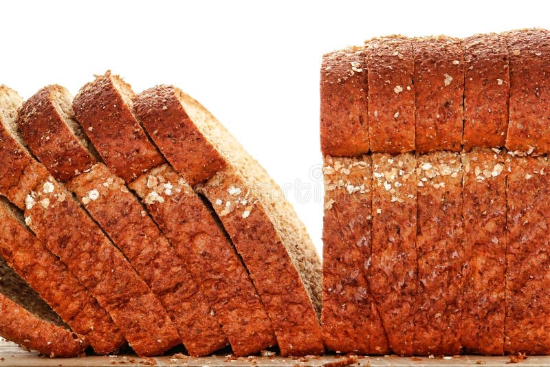 Het gehele Brood van het Brood van de Tarwe dat in Plak op Houten Raad wordt gesneden stock fotografie Het gehele Brood van het Brood van de Tarwe dat in Plak op Houten Raad wordt gesneden stock fotografie