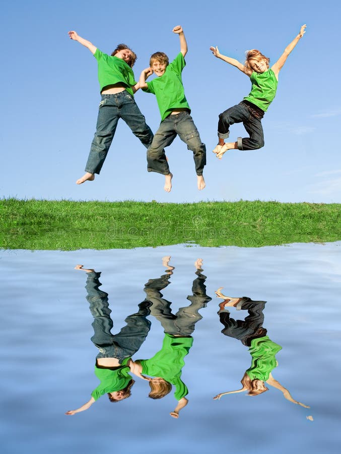 Het gelukkige het glimlachen kinderen springen stock fotografie Het gelukkige het glimlachen kinderen springen stock fotografie