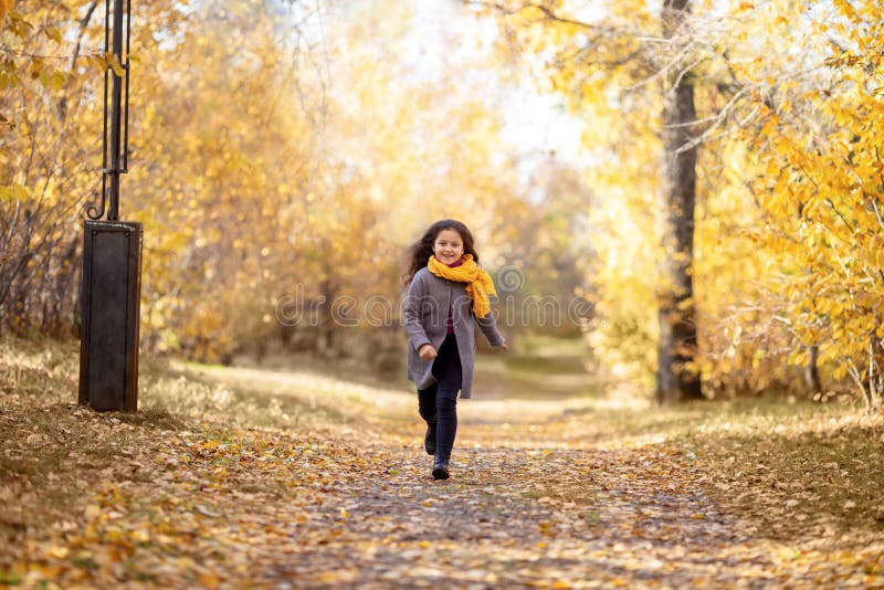 Het gelukkige meisje loopt in de herfstpark stock afbeeldingen Het gelukkige meisje loopt in de herfstpark stock afbeeldingen