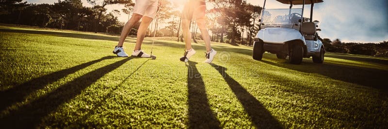 Het gelukkige paar die van de golfspeler hoogte vijf geven royalty-vrije stock fotografie Het gelukkige paar die van de golfspeler hoogte vijf geven royalty-vrije stock fotografie