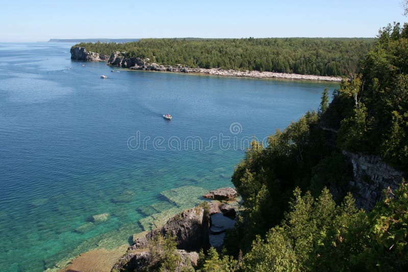 The view from a top the cliffs at Georgian Bay in Bruce Penisula National Park in Ontario, Canada. Featuring a bunch of boats. The view from a top the cliffs at Georgian Bay in Bruce Penisula National Park in Ontario, Canada. Featuring a bunch of boats.