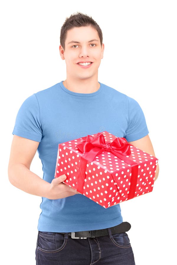 Smiling handsome guy holding a present isolated on white background. Smiling handsome guy holding a present isolated on white background