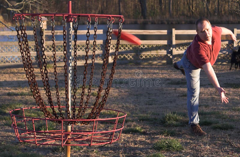A disc golfer playing the sport of disc golf. A disc golfer playing the sport of disc golf