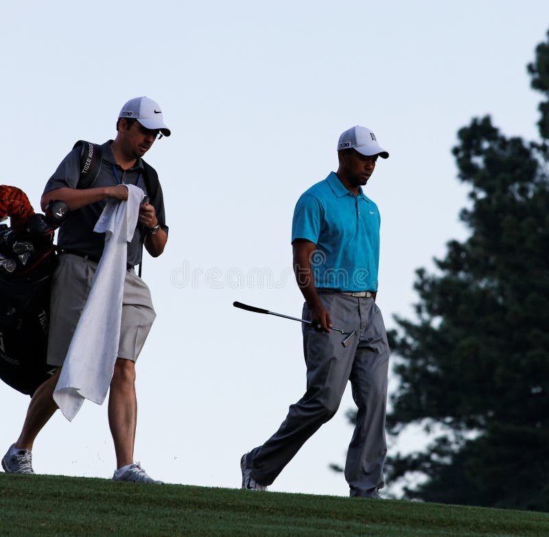 Johns Creek, Georgia, USA - August 10, 2011: Tiger Woods walks with his caddy, Byron Bell, during practice rounds at the 2011 PGA Championship tournament. Johns Creek, Georgia, USA - August 10, 2011: Tiger Woods walks with his caddy, Byron Bell, during practice rounds at the 2011 PGA Championship tournament.