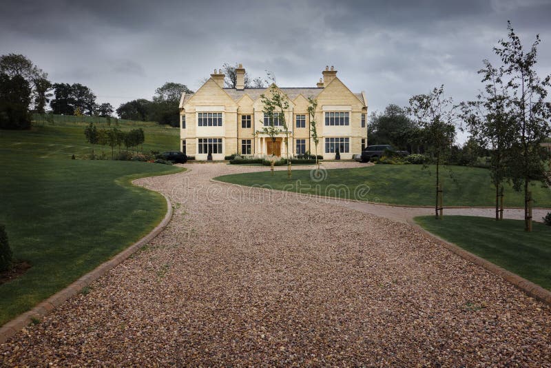 Pebble driveway to a modern stone country home in large grounds. Pebble driveway to a modern stone country home in large grounds.