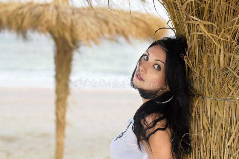 Nice young brunette on a beach near the palm tree. Nice young brunette on a beach near the palm tree