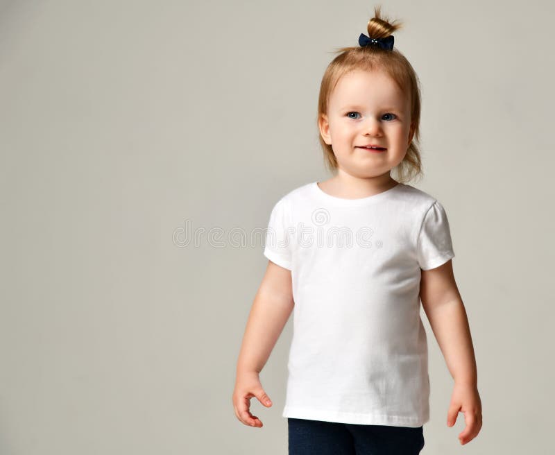 Het jonge geitje die van het de babymeisje van het peuterkind zich in witte vrije tekst ruimtet-shirt bevinden royalty-vrije stock afbeeldingen Het jonge geitje die van het de babymeisje van het peuterkind zich in witte vrije tekst ruimtet-shirt bevinden royalty-vrije stock afbeeldingen