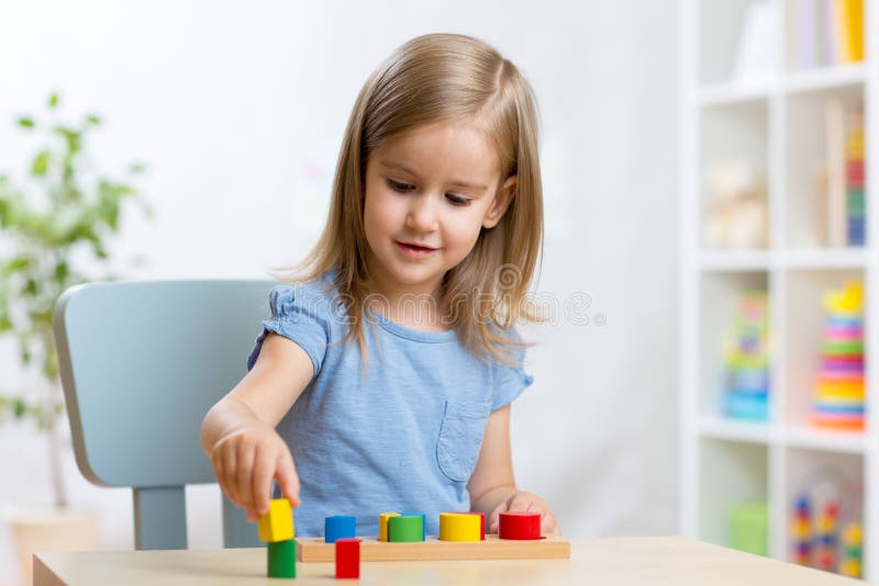 Het jonge geitje van het kindmeisje het spelen met sorteerdersspeelgoed in kinderdagverblijf stock afbeelding Het jonge geitje van het kindmeisje het spelen met sorteerdersspeelgoed in kinderdagverblijf stock afbeelding