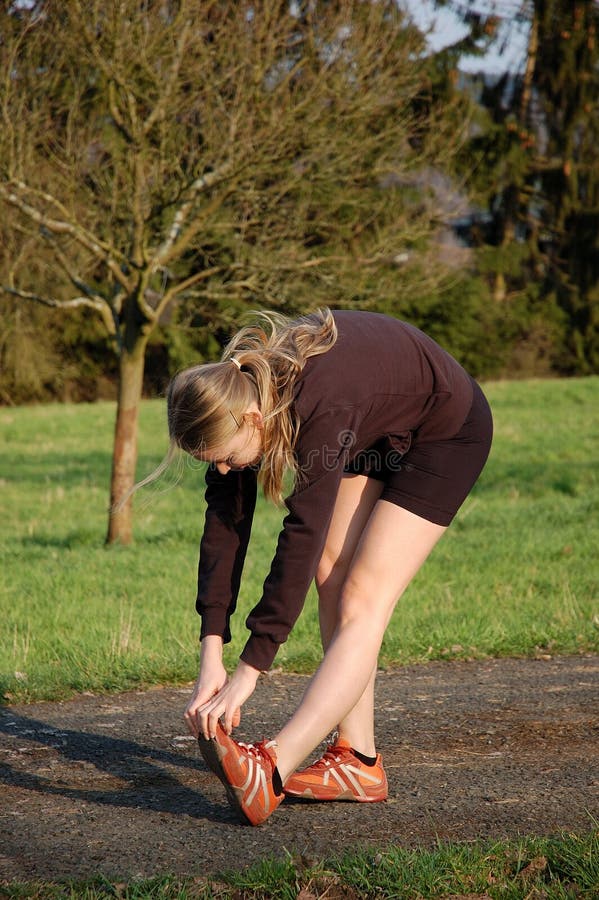 A Young Woman Stretching Outdoors. A Young Woman Stretching Outdoors