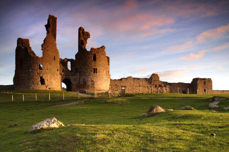 Dunstanburgh Castle Northumberland at sunrise. Dunstanburgh Castle Northumberland at sunrise